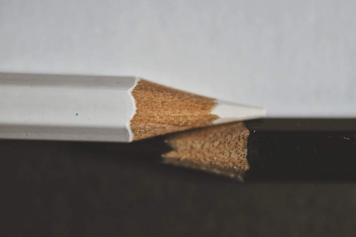 a close up of two pencils on a table