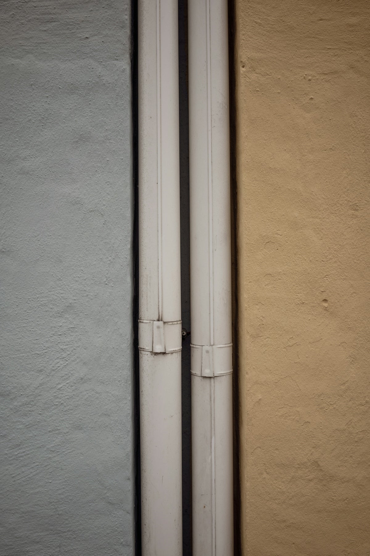 a close up of a white pipe on the side of a building