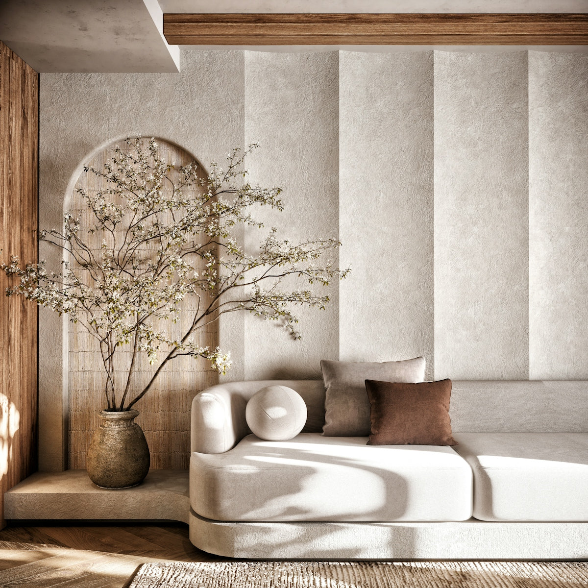 A living room with a white couch and a vase of flowers