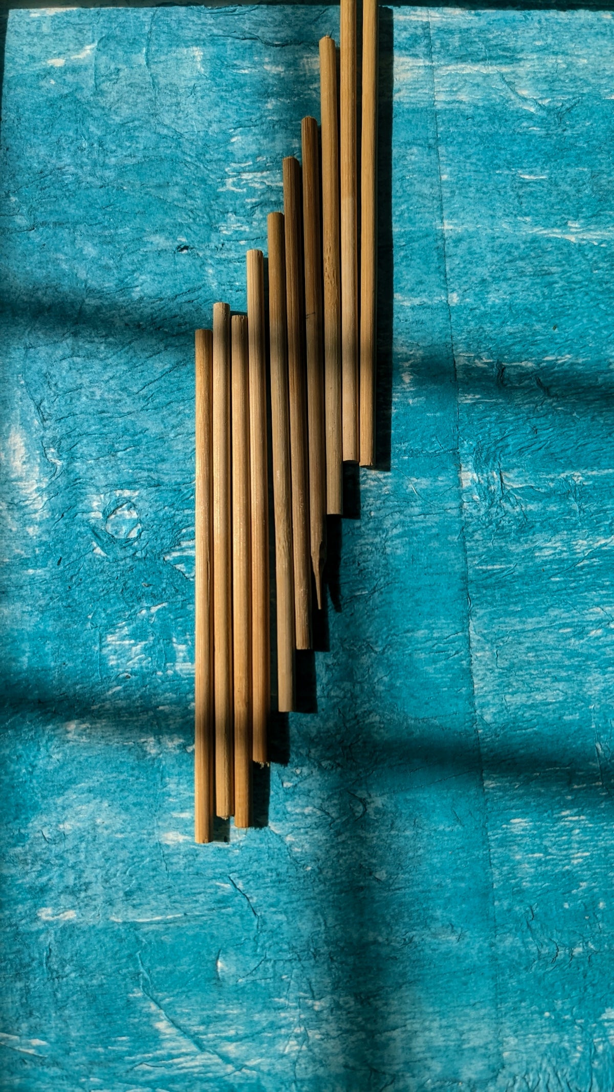 A wooden pipe sticking out of the side of a blue wall