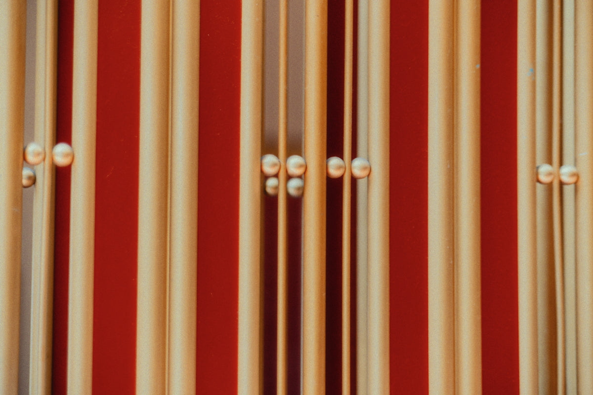 A close up of a pipe with a red wall in the background