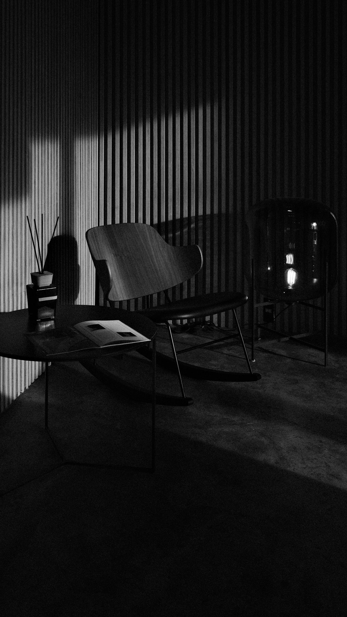 Two chairs and a table with shadows and light.