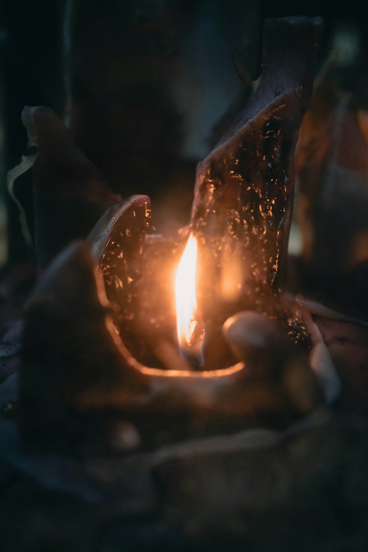 A burning candle with melted wax