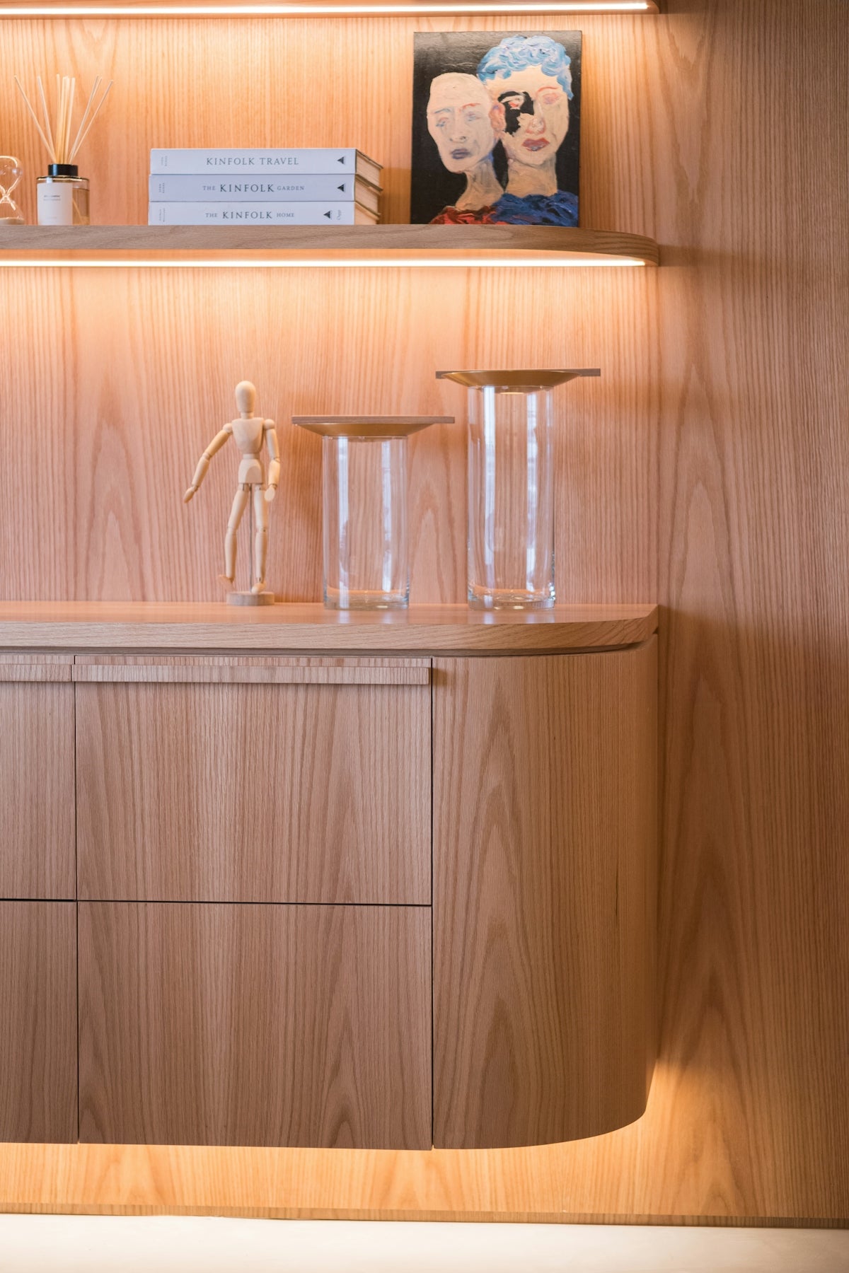 Wooden cabinet with decorative items on shelf.