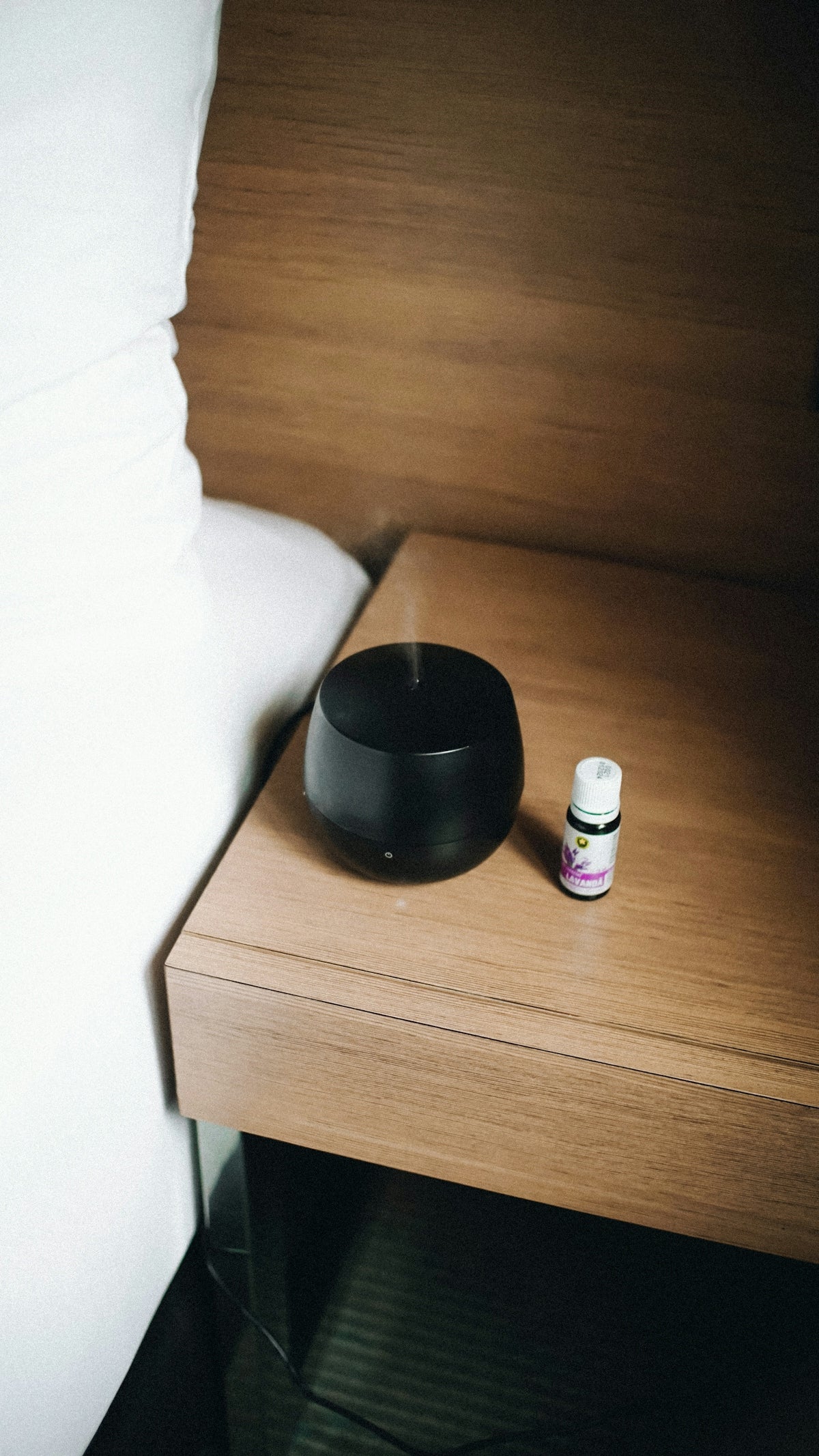a small table with a bottle of essential oils on it
