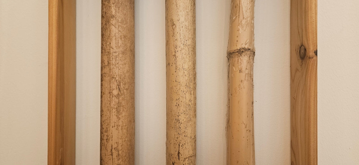 a group of three wooden poles mounted to a wall