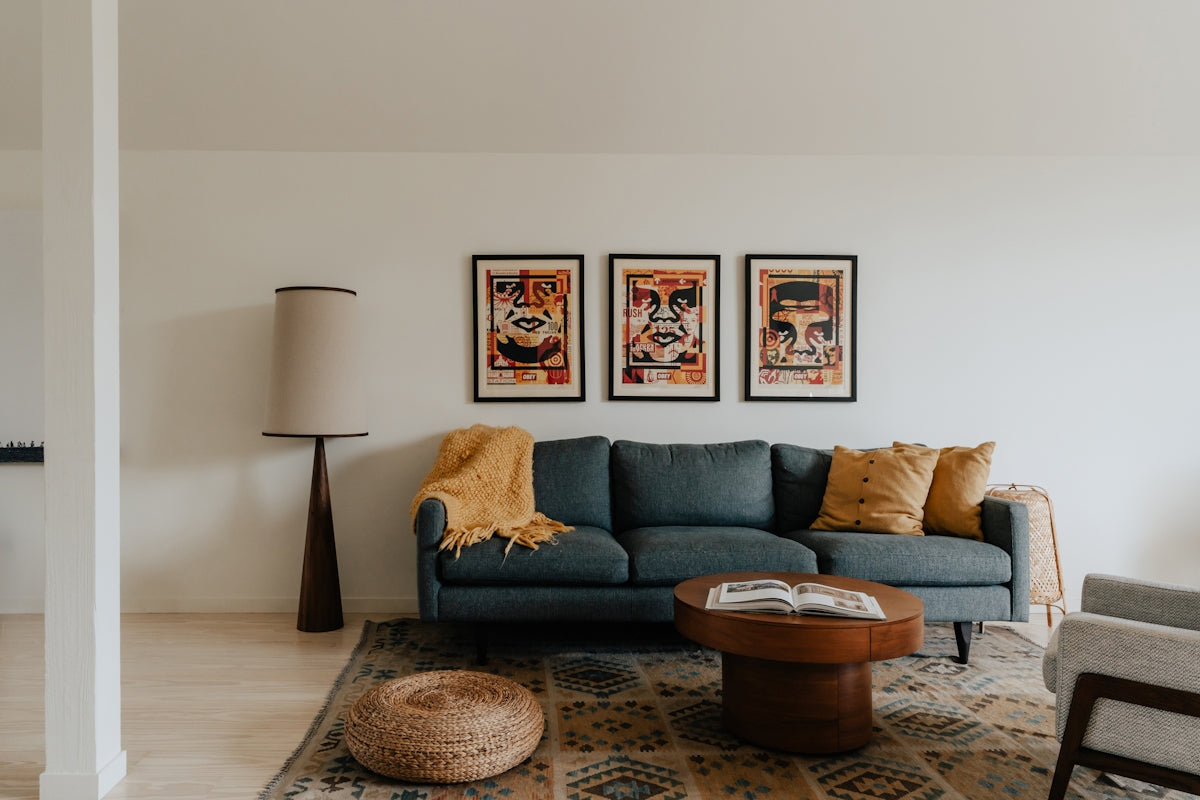 A living room filled with furniture and a painting on the wall