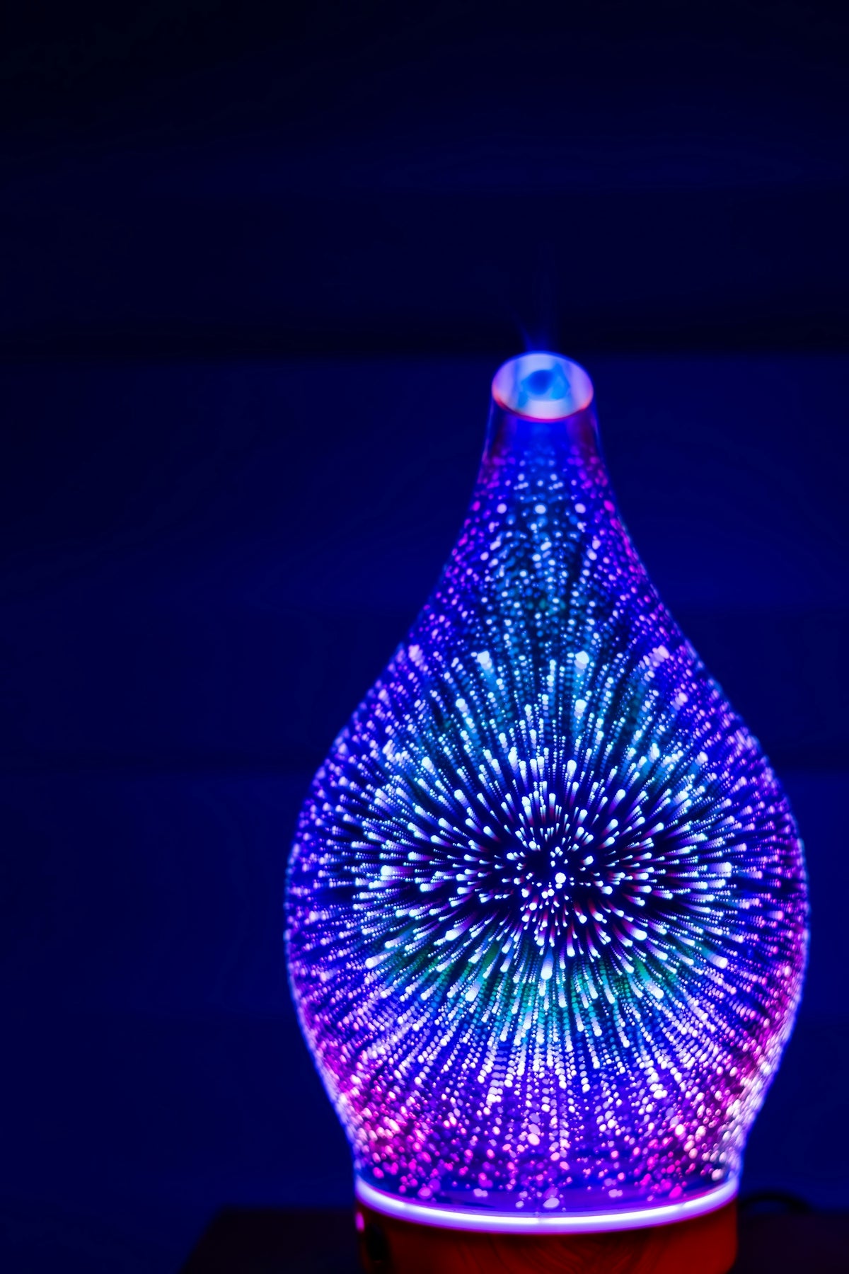 A colorful glass diffuser with glowing lights
